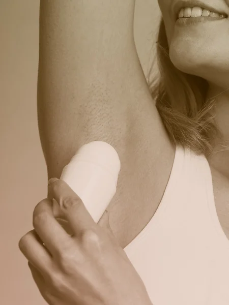 Girl applying stick deodorant — Stock Photo, Image