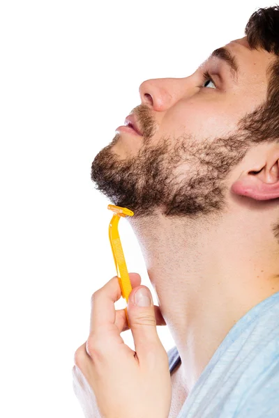 Man holding disposable yellow razor — Stock Photo, Image