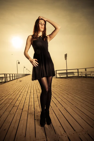 Woman wearing black dress posing — Stock Photo, Image