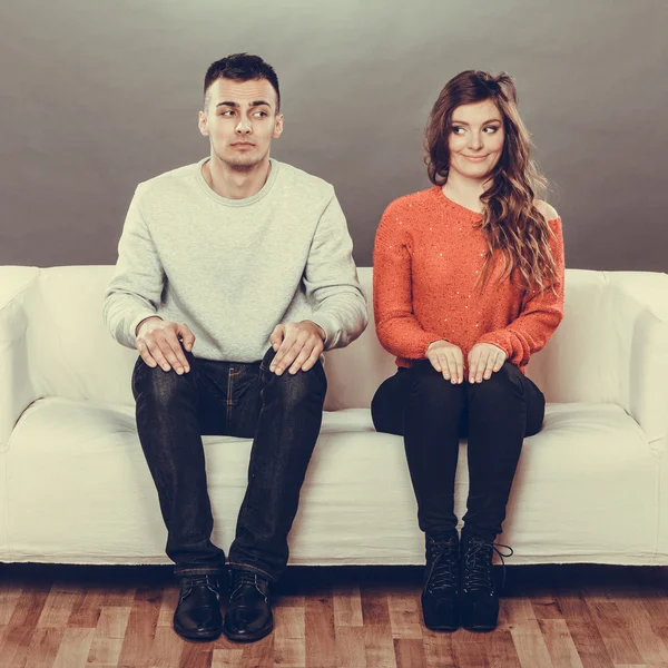 Woman and man sitting on sofa — Stock Photo, Image