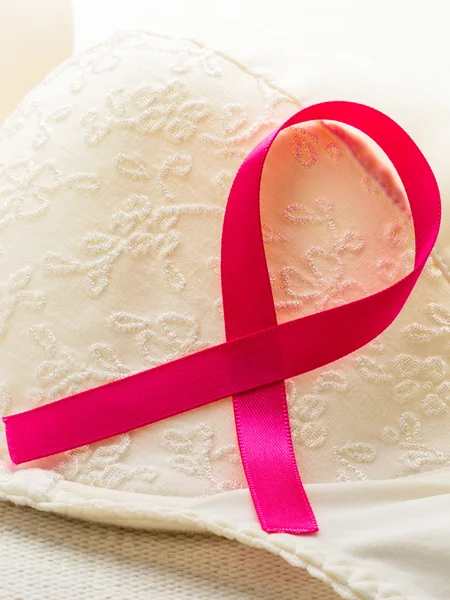 Pink ribbon on female bra. — Stock Photo, Image
