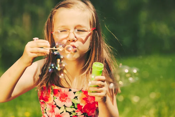 Girl  blowing soap bubbles — Stock Photo, Image