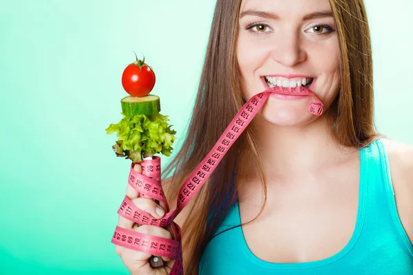 Woman biting measuring tape — Stock Photo, Image