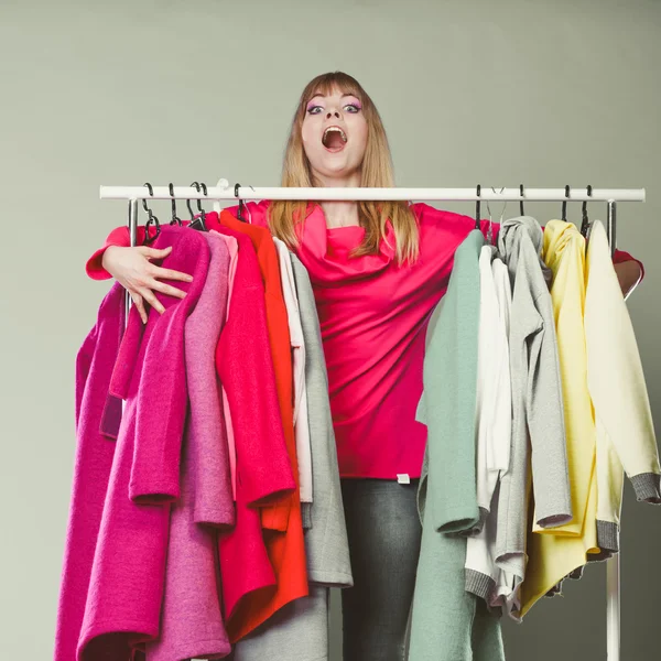 Funny woman taking all clothes in mall or wardrobe — Stock Photo, Image