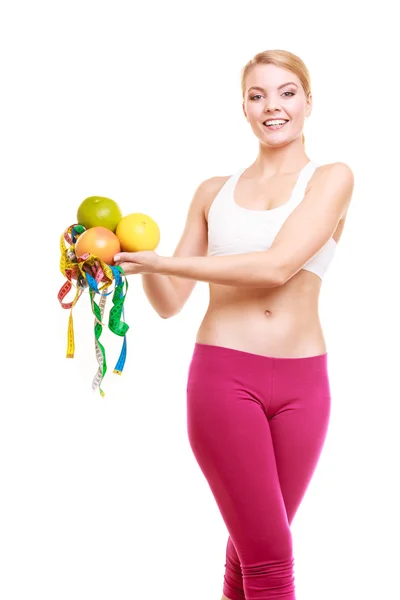 Happy woman holding grapefruits and tape measures. — Stock Photo, Image