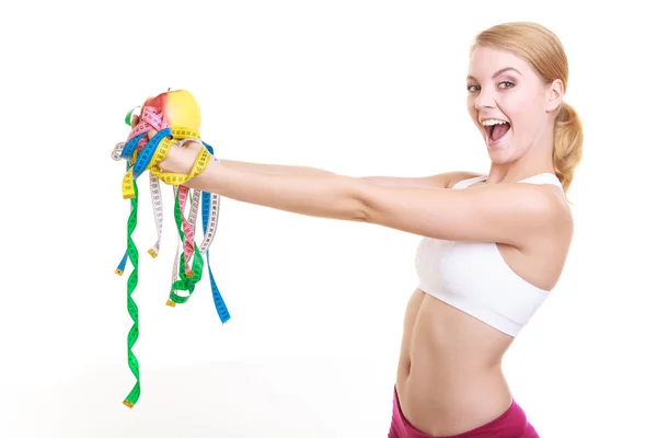 Happy woman holding apple and tape measures. — Stock Photo, Image