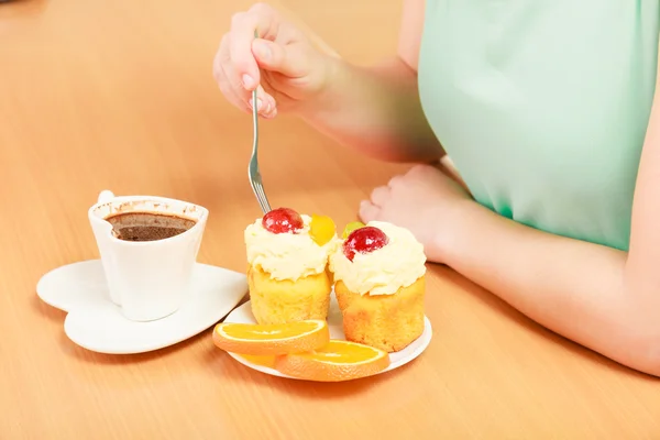 Human hands with coffee and cake. Gluttony. — Stock Photo, Image