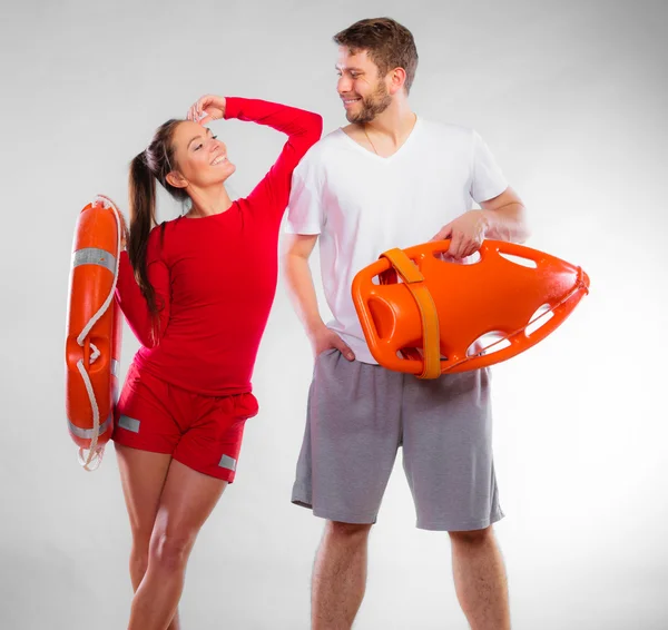 Lifeguards in life vest with ring buoy. Stock Photo by ©Voyagerix 125109556