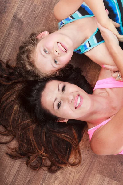 Happy family. Mother and kid lying on home floor. — Stock Photo, Image