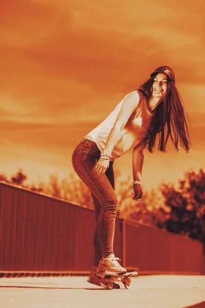 Teenage girl skater riding skateboard on street. — Stock Photo, Image