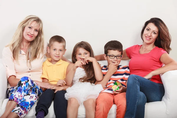 Happy family. Mothers and kids on sofa at home. — Stock Photo, Image