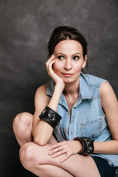 Woman in leather handcuff — Stok fotoğraf