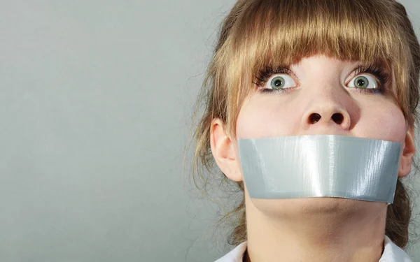 Scared woman with mouth taped — Stock Photo, Image