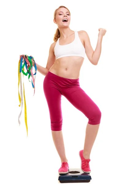 Woman clenching fists measuring on weighing scale. — Stock Photo, Image