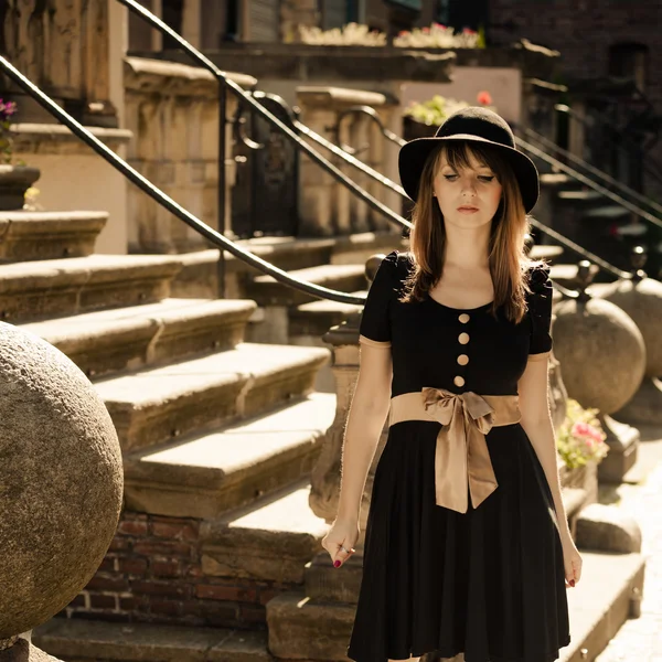 Retro style fashion woman in old town — Stock Photo, Image