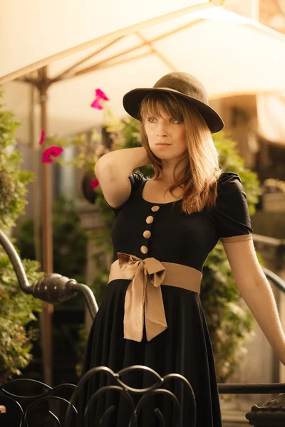 Retro style fashion woman in old town — Stock Photo, Image