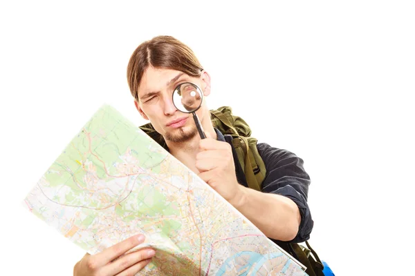 Man tourist reading map with magnifying glass — Stock Photo, Image