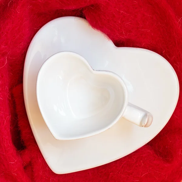 Empty heart shaped cup on red — Stock Photo, Image