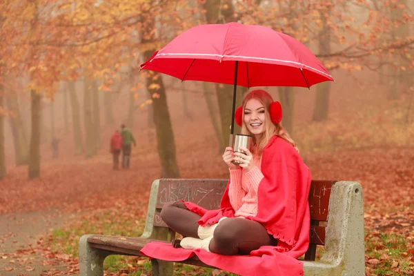 Mujer tomando café caliente relajándose en el parque de otoño —  Fotos de Stock