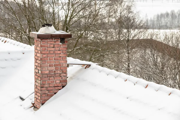 Red chimney and roof covered with snow — Stock Photo, Image