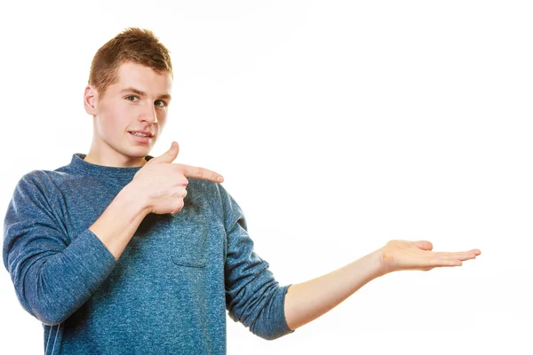 Young man holding open palm showing copy space — Stock Photo, Image