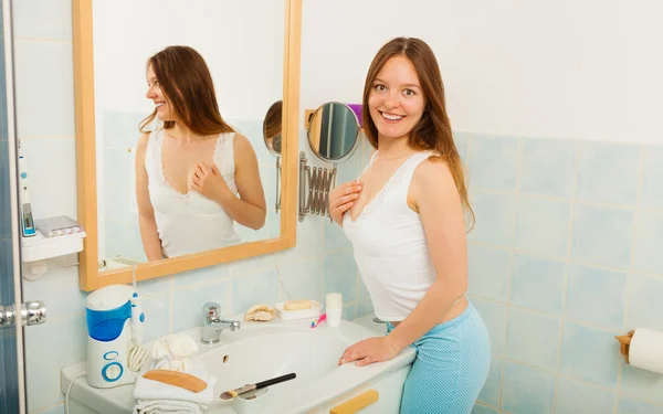 Girl standing in front of mirror — Stock Photo, Image