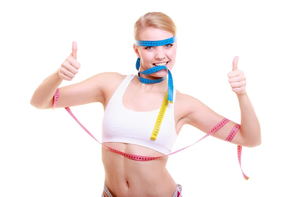 Obsessed fitness woman with a lot of colorful measure tapes — Stock Photo, Image