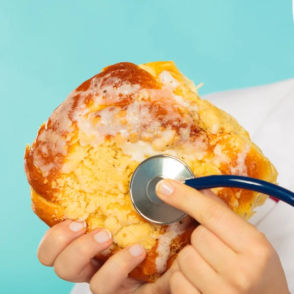 Doctor with fattening junk food — Stock Photo, Image