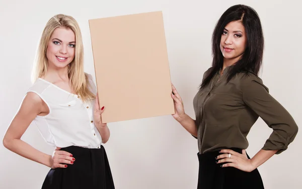 Two women holding blank board — Stock Photo, Image