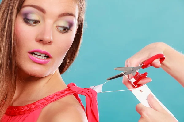 Woman cutting off removing label board price tag. Stock Image