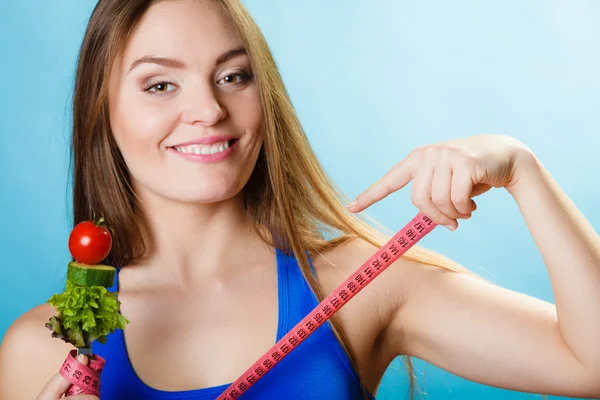 Girl holding fork with vegetables — Stock Photo, Image