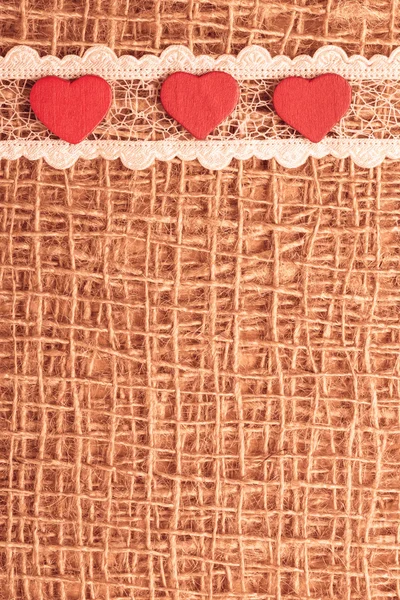 Red hearts on abstract cloth background — Stock Photo, Image