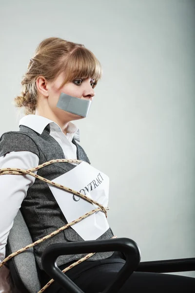 Businesswoman bound by contract with taped mouth. — Stock Photo, Image