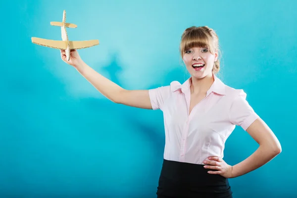 Woman thinking about vacation holds airplane — Stock Photo, Image