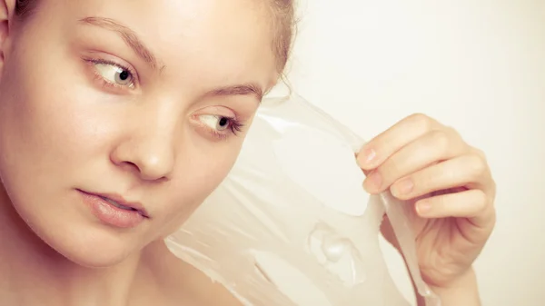 Girl removing facial peel off mask — Stock Photo, Image