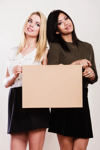 Two women with blank board — Stock Photo, Image