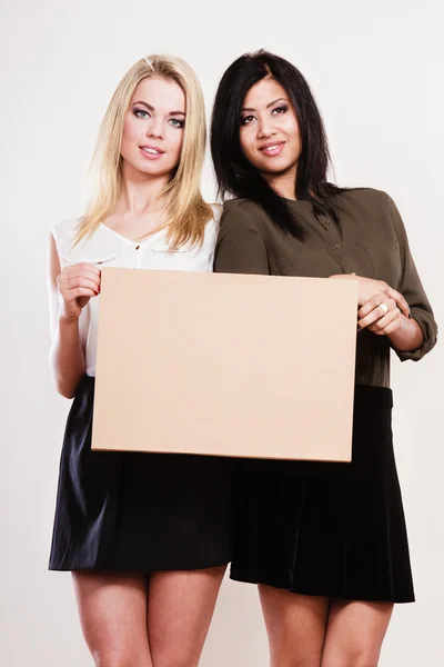 Two women with blank board — Stock Photo, Image