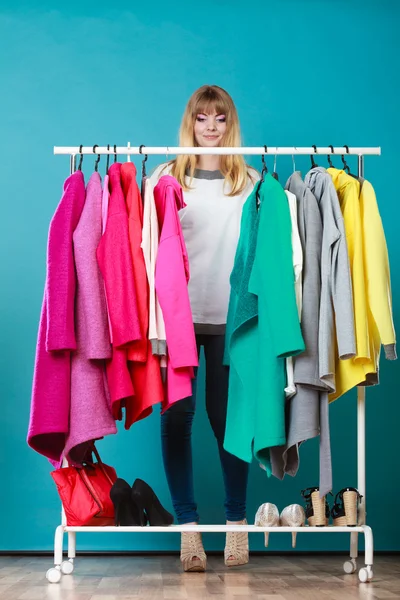 Woman choosing clothes to wear in mall or wardrobe — Stock Photo, Image
