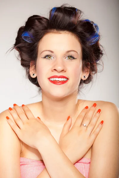 Girl in hair curlers on gray — Stock Photo, Image