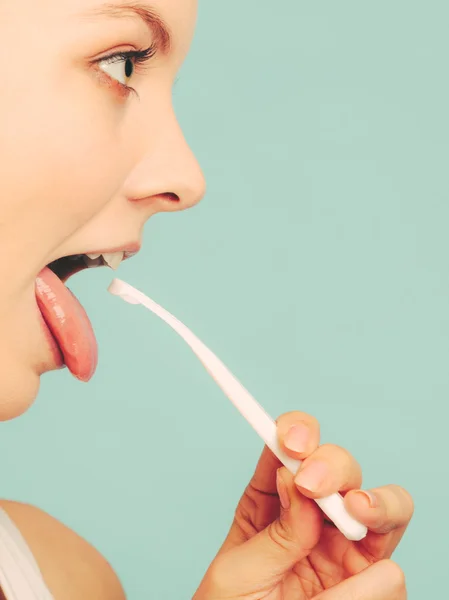 Girl with tongue cleaner. — Stock Photo, Image