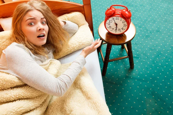 Woman  turning off alarm clock — Stock Photo, Image