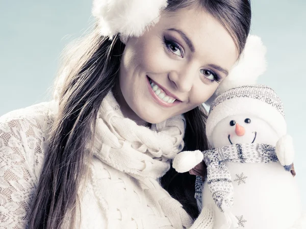 Woman holding little snowman — Stock Photo, Image