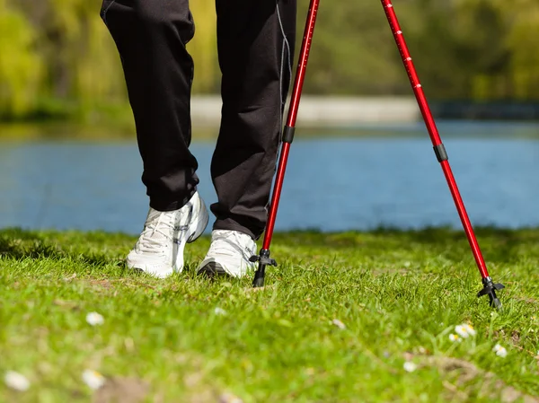 Nordic walking. Female legs hiking in the park. — Stock Photo, Image