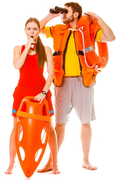 Lifeguards in life vest with ring buoy whistling. — Stock Photo, Image