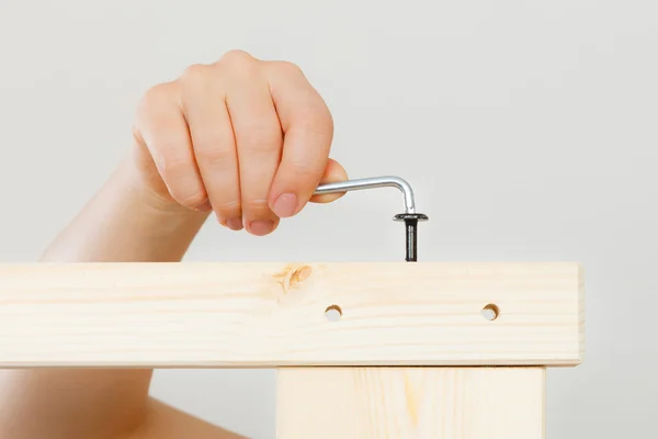 Assembling wooden furniture using scredriver. DIY. — Stock Photo, Image