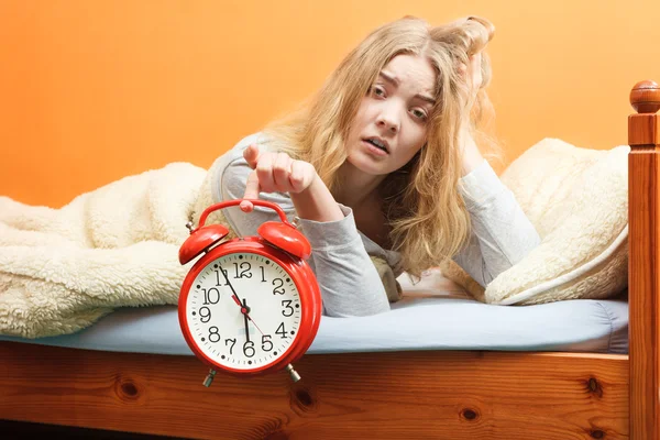 Unhappy woman waking up with alarm clock. — Stock Photo, Image