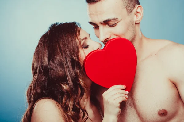 Loving couple kissing behind red heart. Love. — Stock Photo, Image