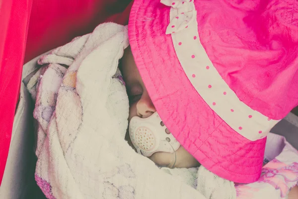 Closeup of little baby covered with pink hat. — Stock Photo, Image