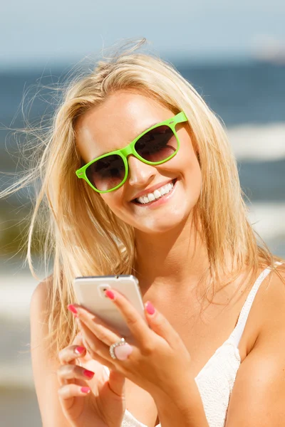 Chica en la playa con teléfono. — Foto de Stock