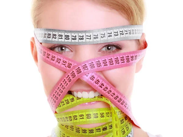 Obsessed fitness woman with a lot of colorful measure tapes — Stock Photo, Image